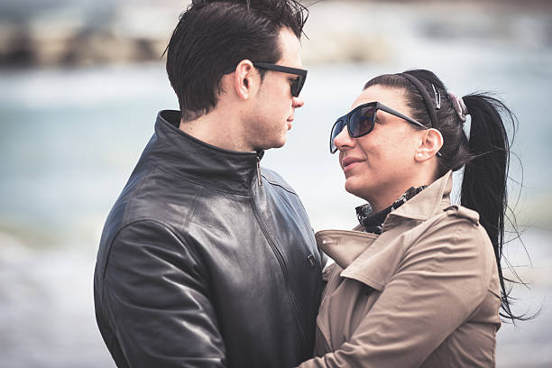 istock couple embracing and flirting at beach 180760994