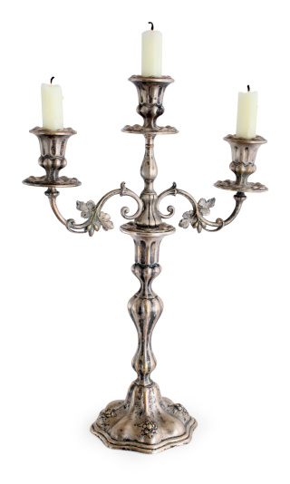 Vintage silver plated candlestick holder isolated on white.