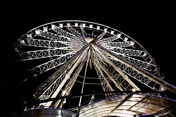 istock Night rider: illuminated Ferris Wheel turns under nighttime sky 180761553