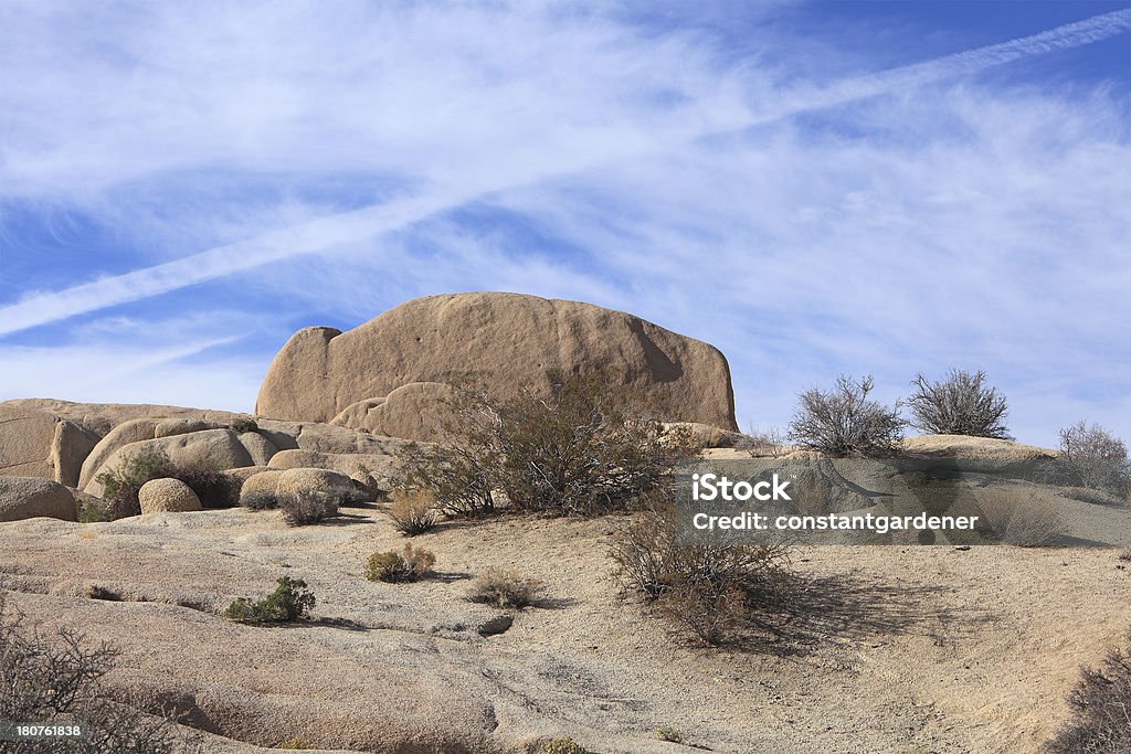 Joshua Tree National Monument Boulders And Jet Stream Natural Geological landscape at Joshua Tree National Monument California.  Located just outside of Palm Springs California. Arid Climate Stock Photo