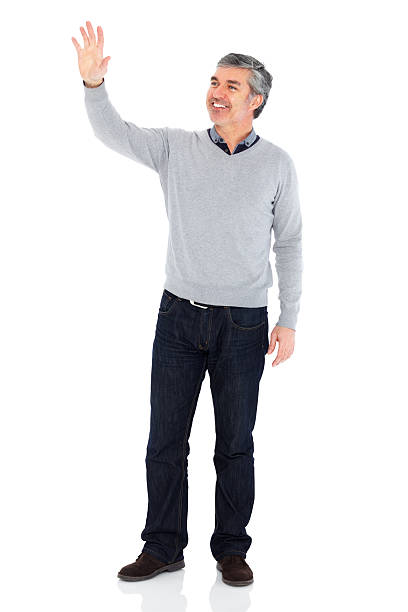 istock Smiling mature man waving hand on white 180761986