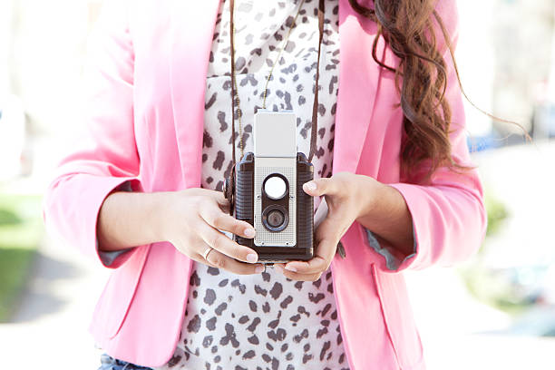 istock woman hands taking picture with vintage camera 180762113