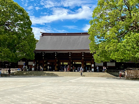Tokyo, Japan - April 17, 2014: Large wooden torii gate marking the entrance to the Meiji shrine in Yoyogi Park, Tokyo.