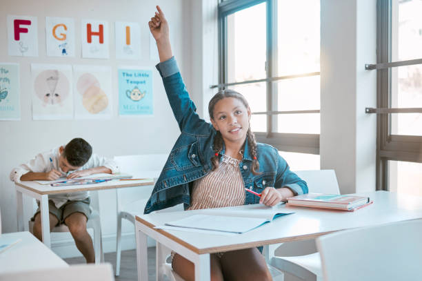 istock Education, black girl in class and question with hand in air, studying and learning for knowledge, answer or excited. African American female, young kid or child with arm raised for asking and growth 1807673860