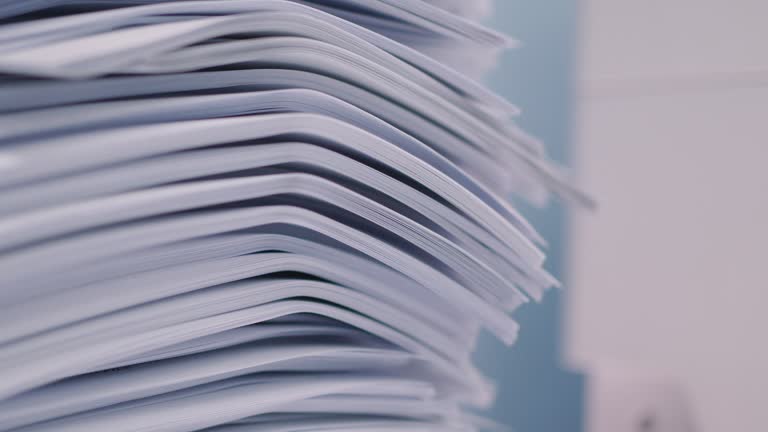 Stack of documents on desktop in office wait to copy by copier machine.