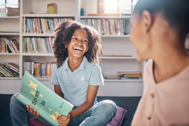 Education, storytelling or happy students in a library or classroom or for learning development. Smile, kids or excited young children reading funny fantasy or English literature books at school