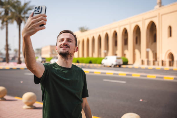 istock Young Caucasian man taking selfies while outdoors in Kuwait 1807685216