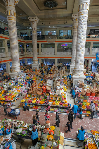 Dushanbe, Tajikistan - November 11, 2023: People shopping in the main hall of Mehrgon market in Dushanbe, Tajikistan.