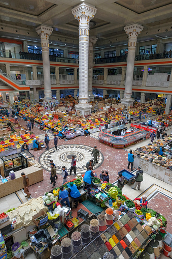 Dushanbe, Tajikistan - November 11, 2023: People shopping in the main hall of Mehrgon market in Dushanbe, Tajikistan.