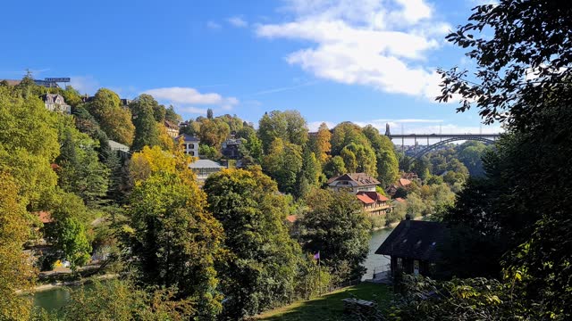 Old Houses At The Riverbank And Steel Bridge Over Aare River In Bern