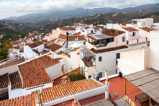 View over the tiled rooftops of Frigilana, one of the famous Pueblos Blancos (white villages) of Andalucia, Spain. Inhabited for about 5000 years, the basis of the current town dates from the 9th century. Frigiliana was voted the prettiest village in Andalucia by the Spanish Tourist Board.