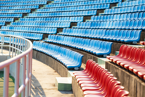 A row of seating chair in sport track, close-up and selective focus. Sport object/background pattern photo.