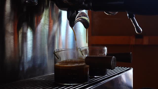 preparing coffee machine and brewing espresso coffee at small coffee shop