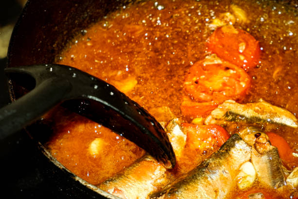 Cooking sardines in tomato sauce