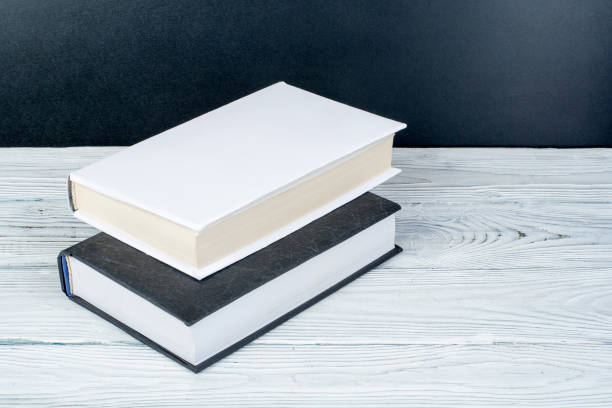 istock Hardback books on wooden table, white background. Back to school. Copy space for text. Education business concept. 1807733125