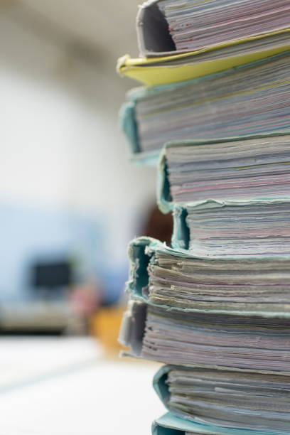 istock Close-up Stack of papers, documents and files. Large stack of files, documents, paperwork on desk. Paperwork: messy stack of files, documents and papers in office. 1807735358