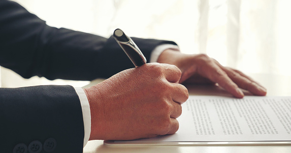 Asian business man using pen signing on new contract to starting projects in conference room. Close up manager businessman hands sign contract working meeting. Business agreement concepts.