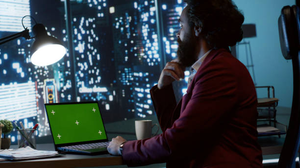 istock Company CEO works with laptop and greenscreen display 1807743624