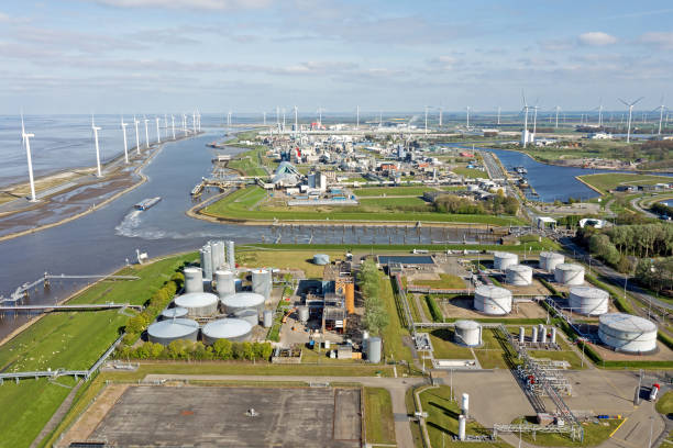 aerial from windmills and industry at eemshaven in the netherlands - groningen stockfoto's en -beelden