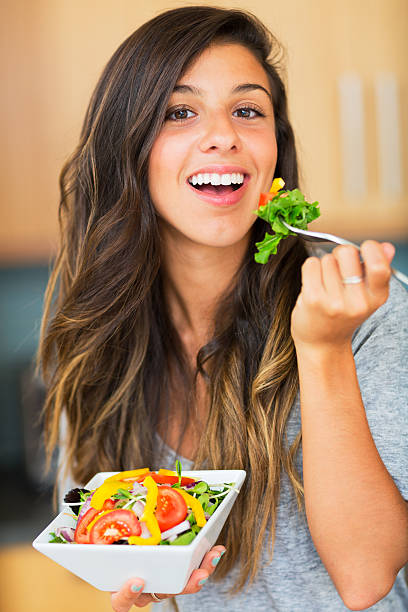 istock Healthy woman eating salad 180778994