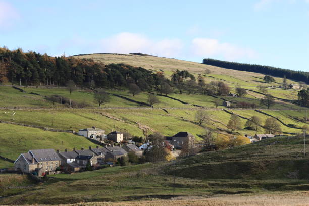 istock View across a rural village in a valley, surrounded by trees and green fields 1807811125