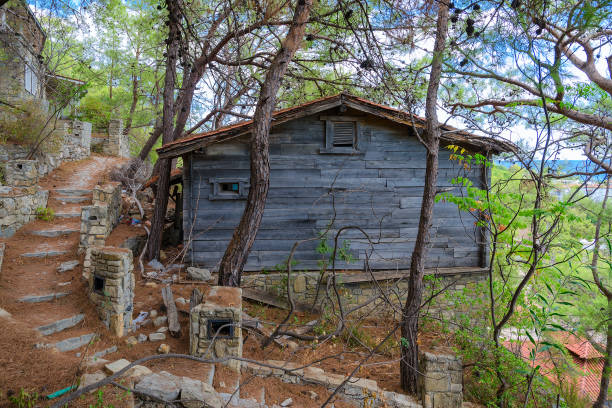 Camyuva, Turkey - September 23, 2022: Path of stone steps under layer of fallen pine needles between cottages in abandoned five-star hotel (formerly Holiday Area Eco Dream Club Sea Resort by Naturland hotel chain)