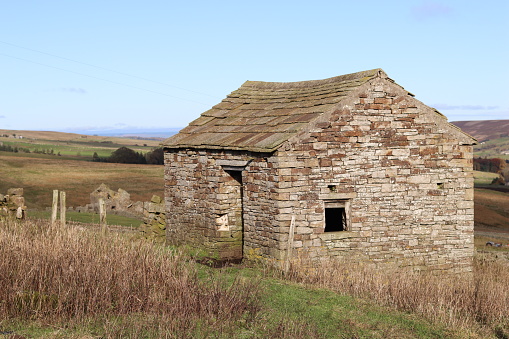 Traditional old stone barn in a rural field