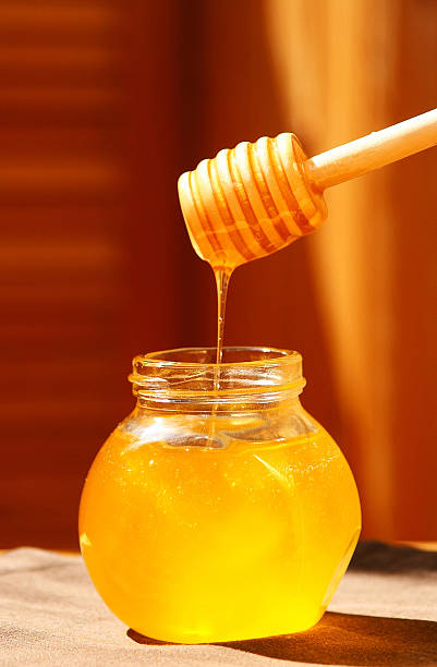 istock Jar of honey with wood stick 180782946