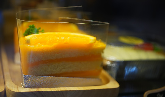 Orange cake in a black plate