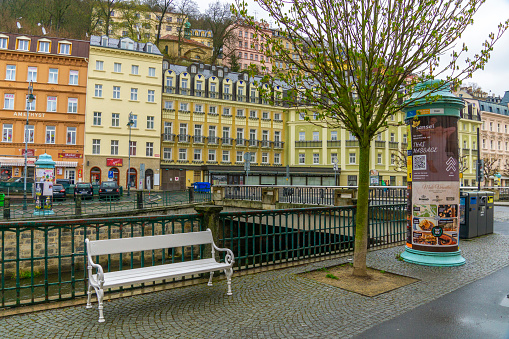 Karlovy Vary CZ - April 26. 2022 famous spa town in the Czech Republic with thermal springs. Many historic buildings adorn the very beautifully restored old town. There are usually a lot of tourists out and about, unless you are lucky enough to take a photo in the morning. colourful houses of the old town with spring trees