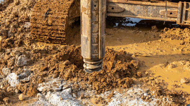 istock bore pile machine is cutting a hole in the muddy ground 1807849859