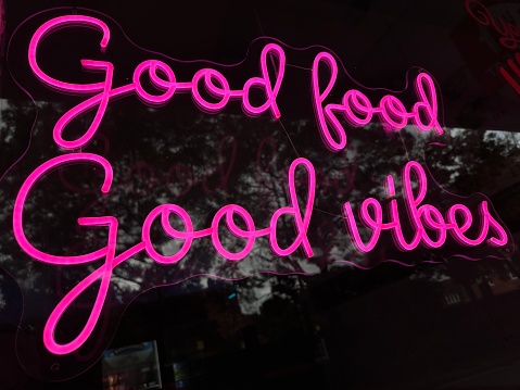 Low angle close up of pink good food good vibes sign