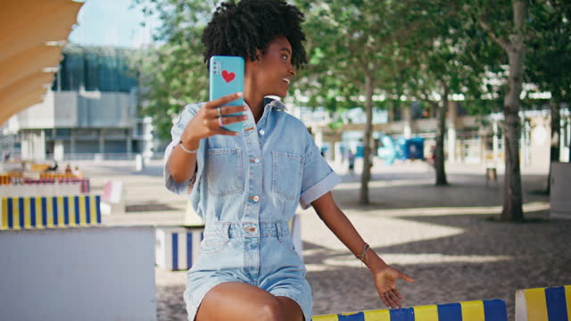 African american girl blogging using smartphone on street. Blogger recording