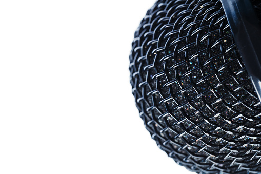 Microphone grille close-up on a white background. Free space