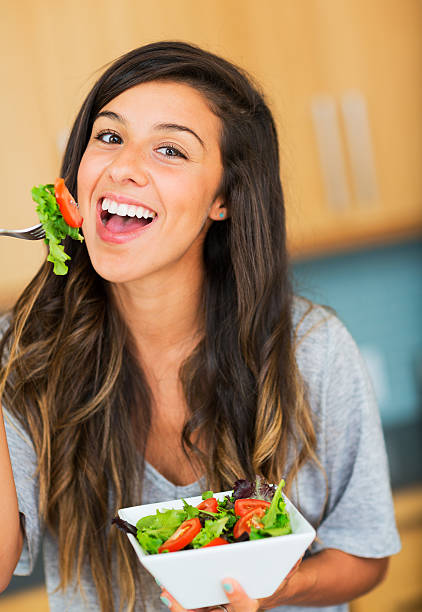 istock Healthy woman eating salad 180787979