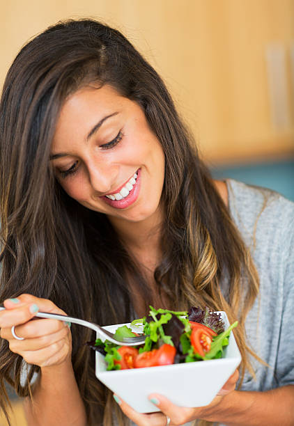 istock Healthy woman eating salad 180787982