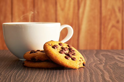 Big hot coffee cup with steam and sweet cookies. Breakfast backgrounds theme