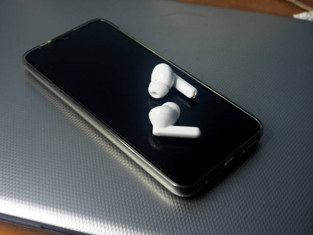 istock white earbuds and smart phone connect together 1807887542