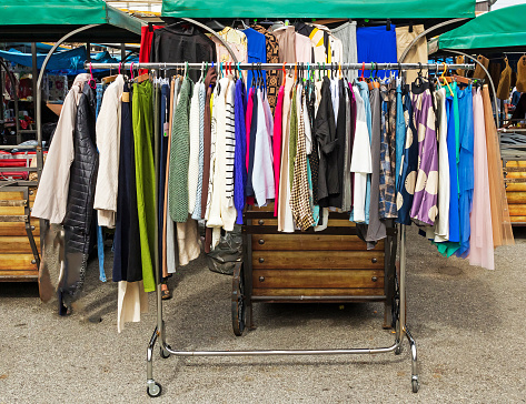 Second hand female clothes sold on flea market outdoors