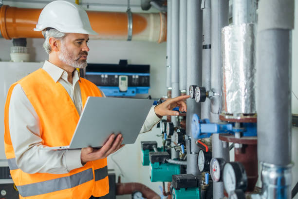 istock Heating plant operator maintaining low pressure steam inside power plant. 1807903533