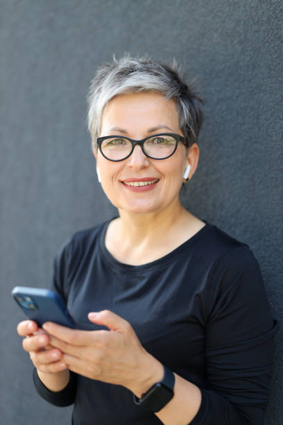 istock Happy senior woman, using a modern smartphone outdoors, reflects a tech-savvy and cheerful sporty elderly lifestyle. 1807905745