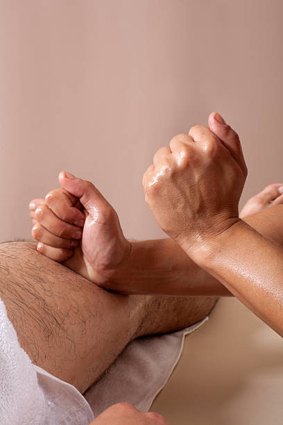 Massagem coxa com o fists - fotografia de stock