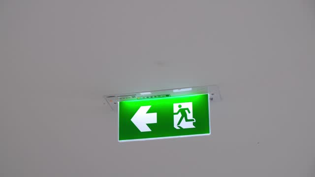Exit Sign attached to the ceiling, Bangkok, Thailand.