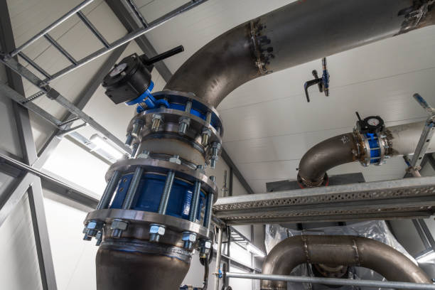 High capacity absorption heat pump during installation. Valve and pipes in foreground(