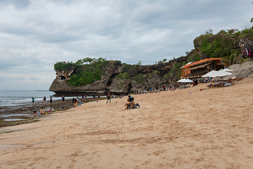 Bali, Indonesia - March 16, 2017: People enjoy the beach at Balangan Beach in Bali.