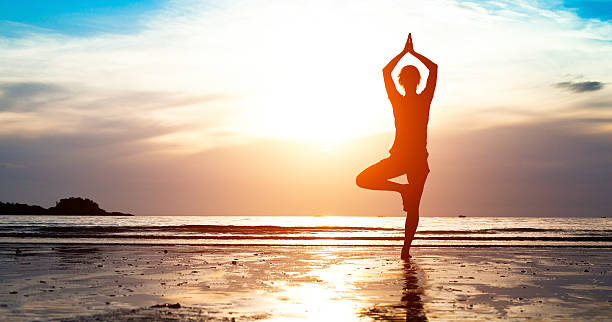 istock Silhouette young woman practicing yoga 180793862
