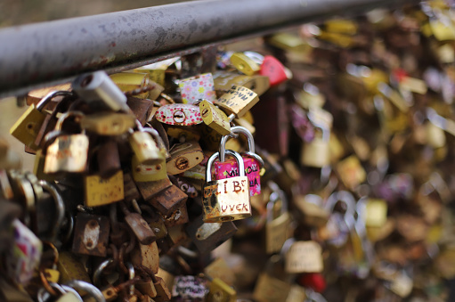 Love locks hanging on bridge. Padlocks as concept of love, relationships, and affection.