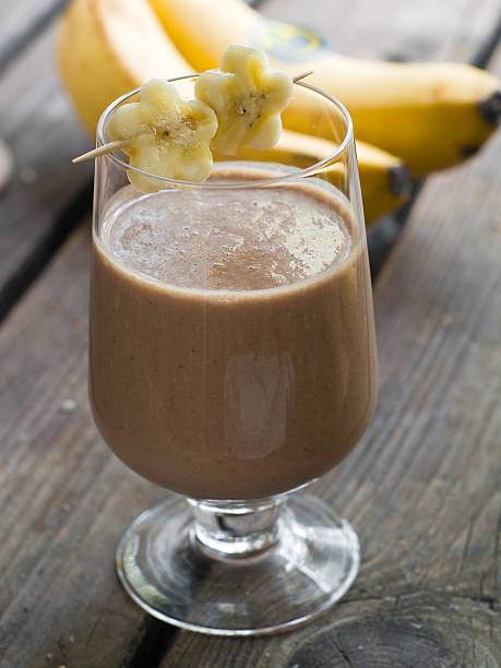 istock Chocolate and banana shake with bananas in background 180794972