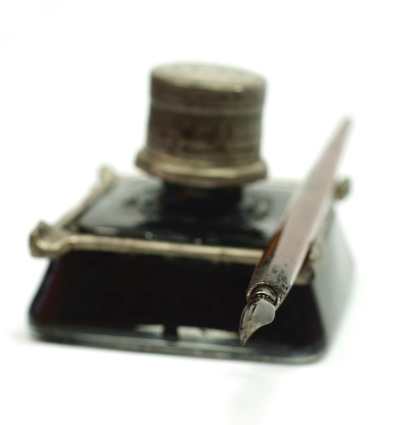 Retro ink bottle with a metal lid and drawing pen