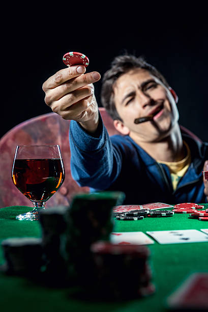 Poker player Poker player holding poker chip dibs stock pictures, royalty-free photos & images